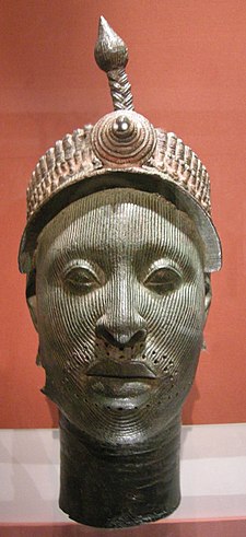 A bronze head on display in a museum.
